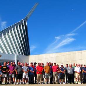 A group standing together in front of the National Marine Corps Museum of their tour