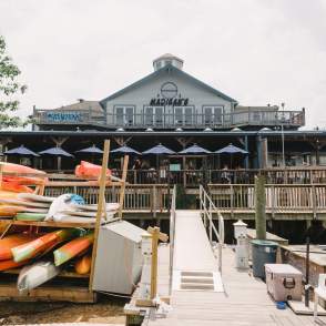 A picture of Madigan's from the riverside with kayaks