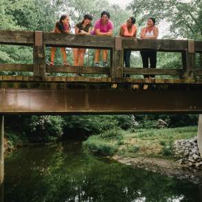 women standing on a bridge