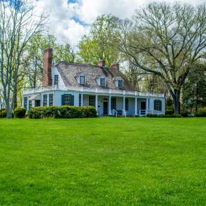 A white house with trees in the background