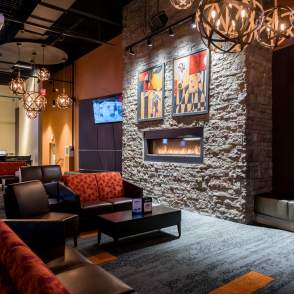 Lounge area with table, chairs and TV at Uptown Alley
