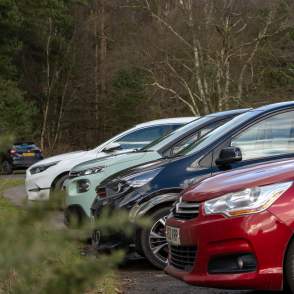 a line of cars in a car park at Willingham Woods