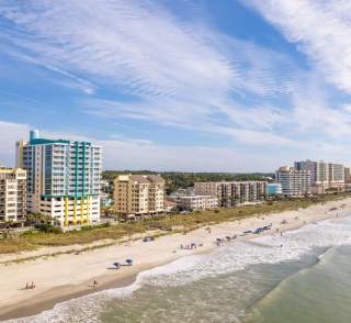 A shoreline view of Crescent Beach with lots of oceanfront resorts.