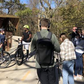 Camera crew films Antonio and Lori at Coler Mountain Bike Preserve.