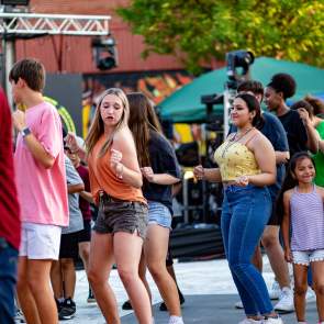 People Dancing at Pat Coursey Park during Cinco De Mayo Celebration to a live band and DJ.