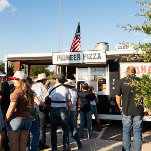 Festival goers in line to get pizza from Pioneer Pizza Truck at the Feels Like Home Festival
