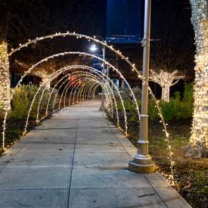 Photo of Lehnis Railroad Museum Christmas Lights Display featuring a light tunnel that leads up to the front doors of the museum.