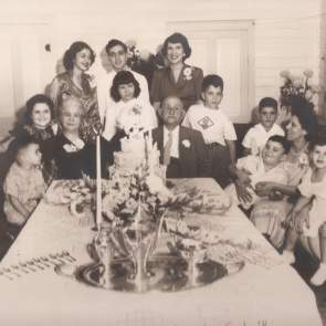 Mr. and Mrs. George Abdalla at a 1949 dinner celebrating their fiftieth wedding anniversary, surrounded by their grandchildren.