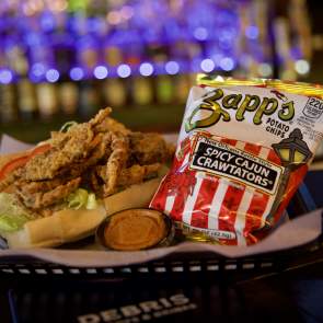 Fried Soft Shell Crab Po-boy and a bag of chips in a basket at Debris Po-Boy