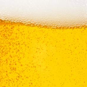 close up of beer with suds