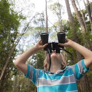 boy with binoculars looking at the sky