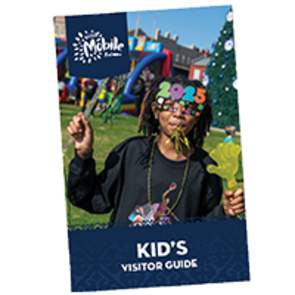 Visit Mobile Kids Visitor Guide cover featuring a young, black girl wearing sunglasses in the shape of 2025.