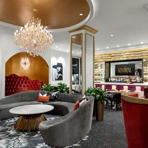 Ornate room with chandelier, seating and a bar