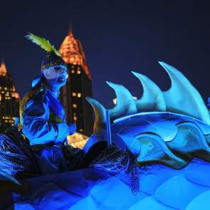 Masked man riding Mardi Gras float