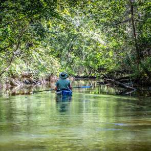 Man in a kayak floating down the river