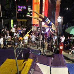 person pole vaulting in front of a crowd