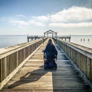 woman in wheelchair on fishing pier at Leesylvania State Park