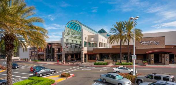 Arden Fair Mall entrance under clear sky, viewed from parking lot
