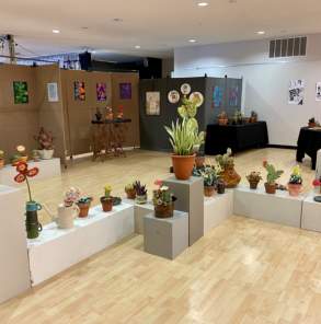 an art display of plant sculptures and other art fill an art center