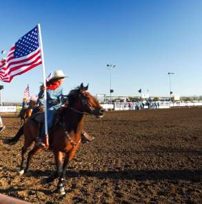 Woman on horse, holding flag of United States