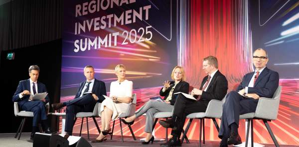 Politicians talking at a panel discussion on stage during the Regional Investment Summit 2025