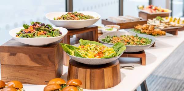 A buffet spread of an assortment of food, next to a window overlooking Birmingham