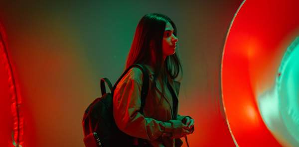 A girl walking through an arts installation