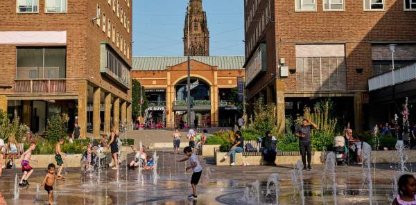 Families playing in a water fountain in Coventry city centre