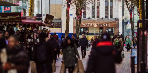 Shoppers on Birmingham New Street, Waterstones is visible in the background.