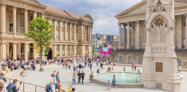 The clock tower, fountain and town house as seen from Paradise Birmingham, with a crowd gathered during the Commonwealth Games 2022