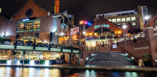 A collection of restaurants in Brindleyplace, taken at night across the water of the canal.
