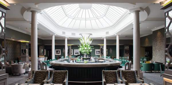 A wide shot of the Brabazon Bar in the Belfry, with sunlight filtering down through an ornate skylight