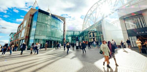 People shopping outside a large shopping centre, Bullring, Birmingham