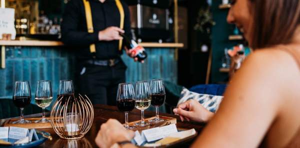 A woman enjoys a drink at a bar