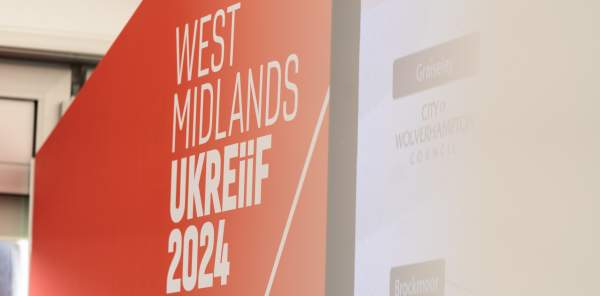 The West Midlands at UKREiiF 2024 logo on the wall at the West Midlands Pavilion