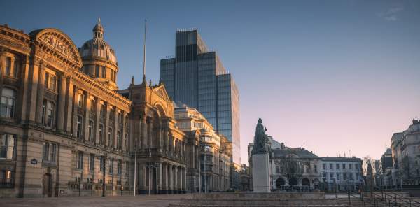 Early morning in Victoria Square, Birmingham, showing council house and statue of Queen Victoria in front of 103 Colmore Row in the distance.