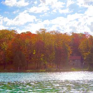 Sun Shimmering on Green Lakes State Park with Fall Trees in Background