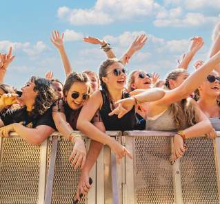 Crowd of young women against the festival barricade in front of stage at ACL Music Festival