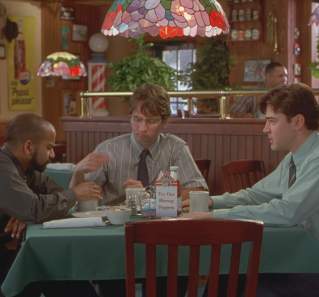 Office Space screengrab showing three men sitting around a table inside Chotchkies restaurant