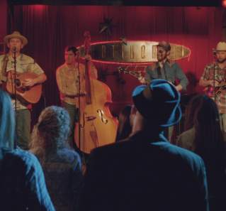 Boyhood screengrab showing a band on stage at the Continental Club in front of a red velvet curtain