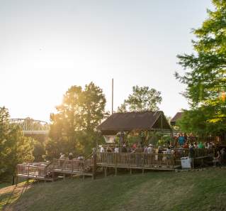 Neighbors Kitchen and Yard deck with bridge behind in Bastrop Texas