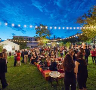 twilight at fair market outdoor event venue with people and twinkle lights in austin texas
