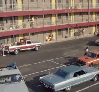 Everybody Wants Some!! screengrab showing the Graham Hall dormitories with red balconies and 1970s-era cars parked in front
