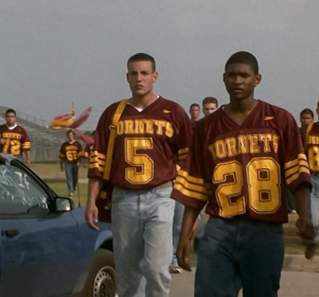 The Faculty screengrab, showing Usher and football players walking away from the Herrington High School Football Field