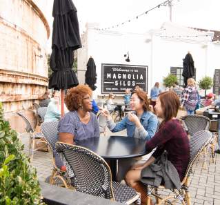 Women sitting together around table on Magnolia Silos patio in Waco Texas