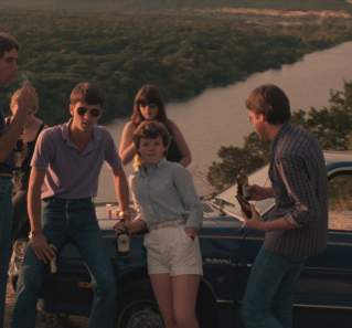 Blood Simple screengrab showing a group of young people leaning up against a car on top of Mount Bonnell
