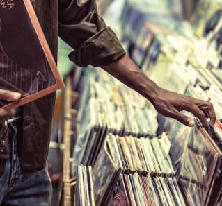 cropped photo of man's hands flipping through vinyl at Waterloo Records