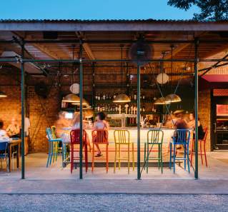 People dining at the colorful bar at Home Slice in Austin Texas