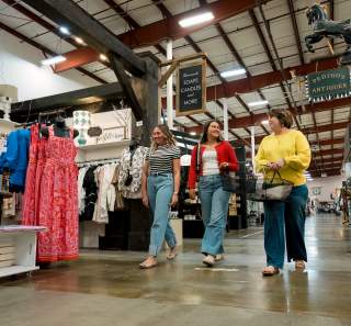 three ladies walking in a large shopping complex