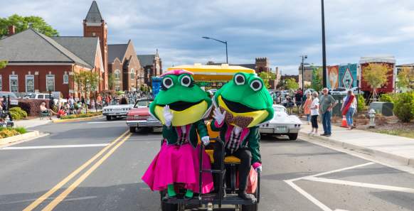 Two frog mascots for Come See Me Parade